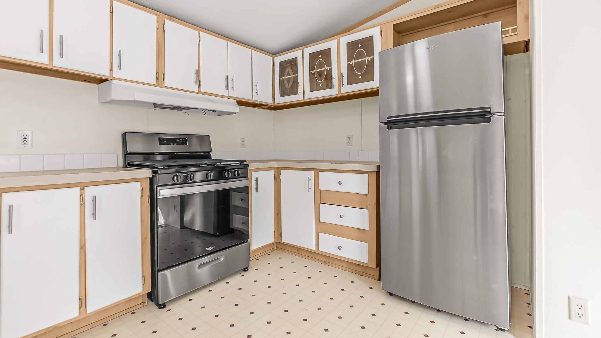 534 Normandy Way Grand Junction, CO 81501 - Photo 15 of 32 a kitchen with stainless steel appliances granite countertop a refrigerator sink and cabinets