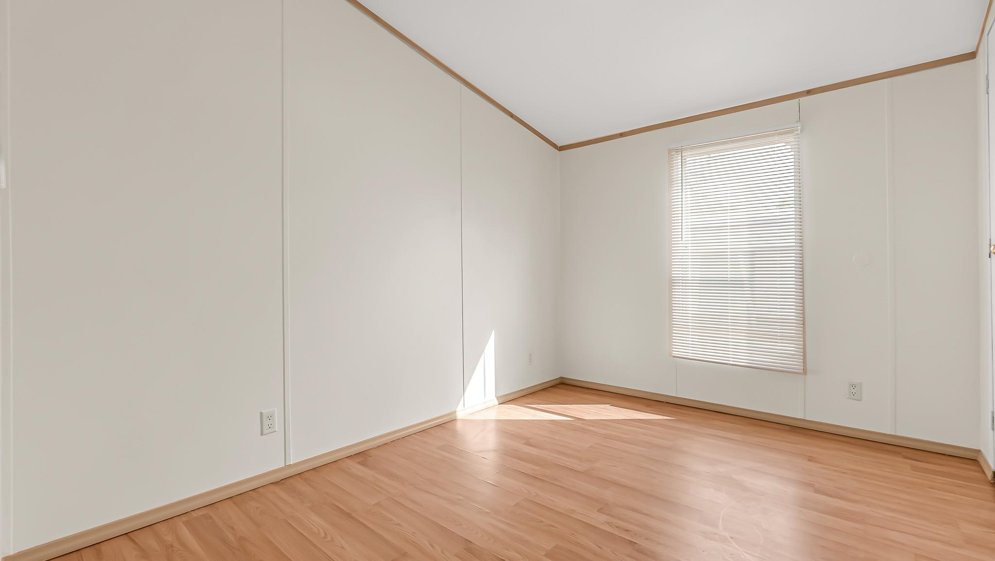 534 Normandy Way Grand Junction, CO 81501 - Photo 23 of 32 an empty room with wooden floor and windows