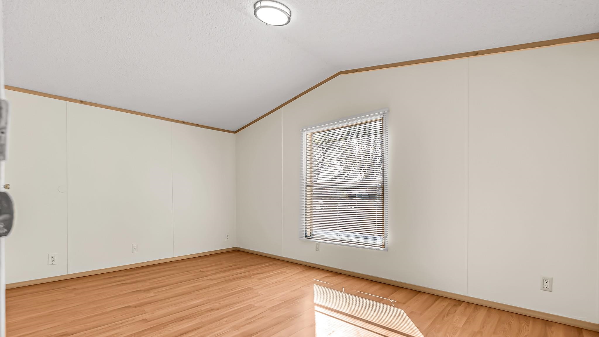 534 Normandy Way Grand Junction, CO 81501 - Photo 26 of 32 an empty room with wooden floor and windows