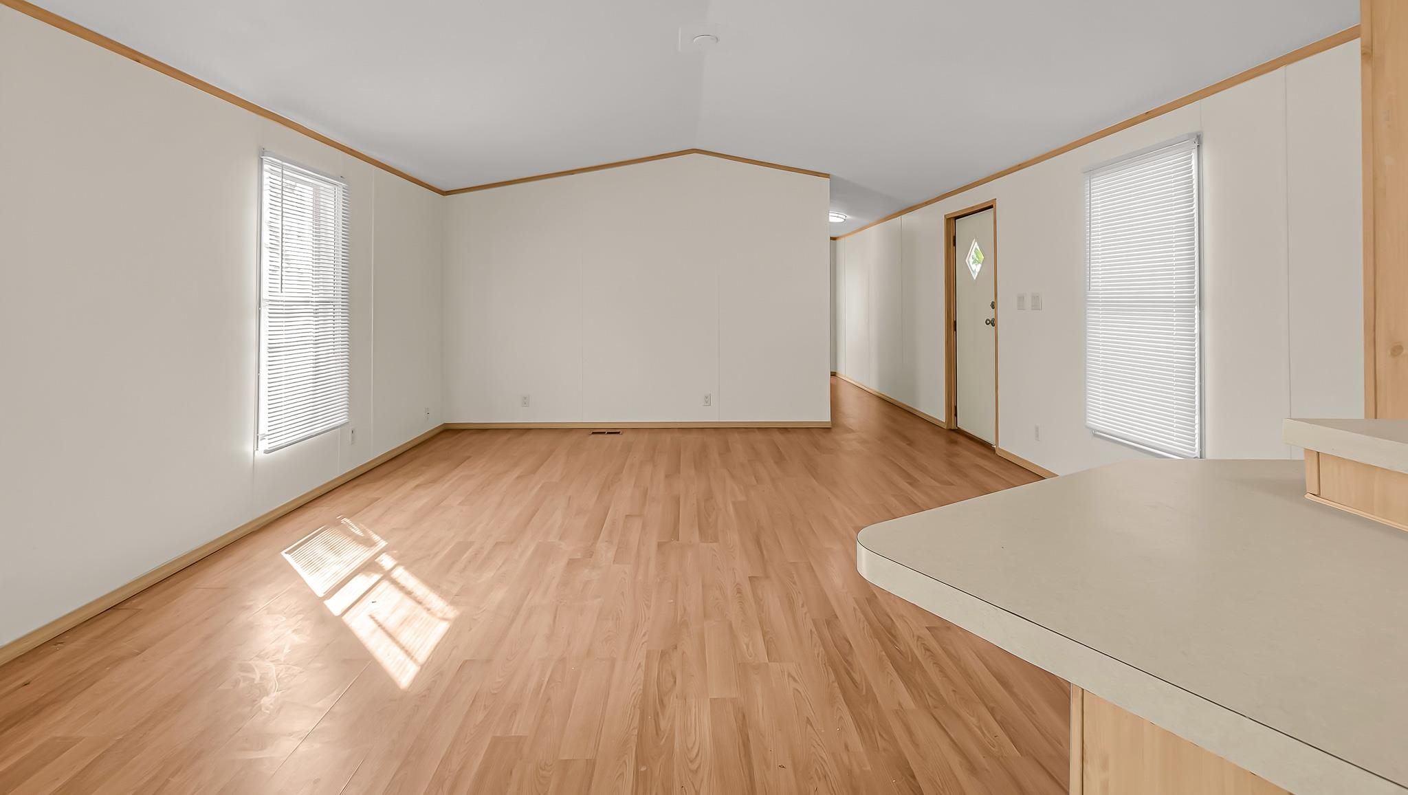 534 Normandy Way Grand Junction, CO 81501 - Photo 10 of 32 an empty room with wooden floor and windows