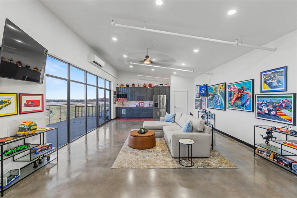 400 Fast Lane, Unit 9 Anna, TX 75409 - Photo 12 of 37 Living area featuring concrete floors, ceiling fan, recessed lighting, and a high ceiling