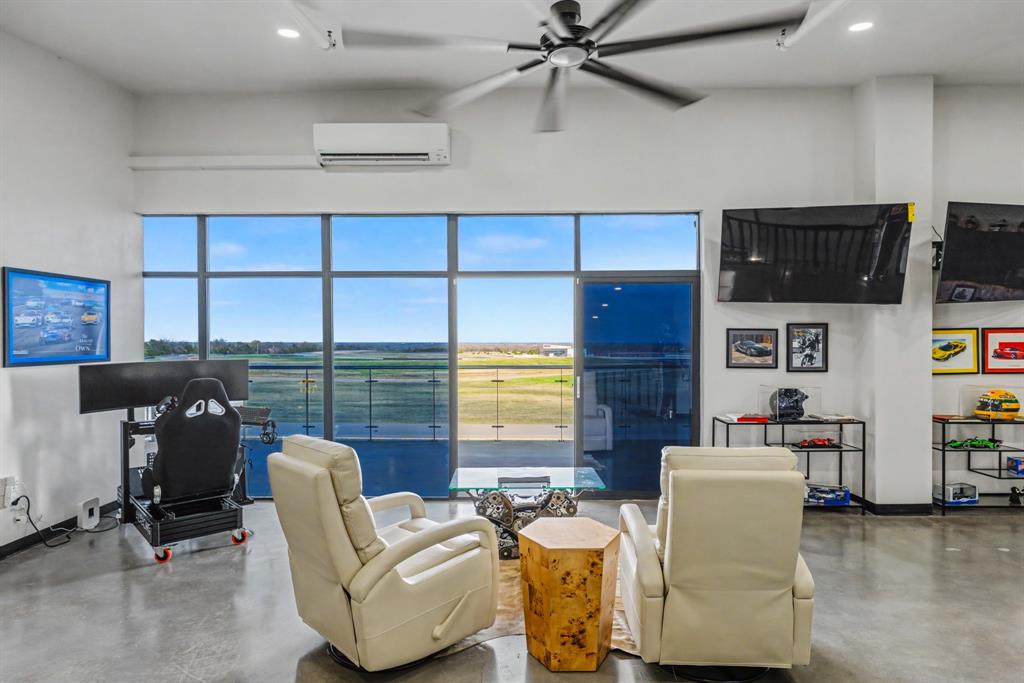 400 Fast Lane, Unit 9 Anna, TX 75409 - Photo 16 of 37 Living room featuring finished concrete flooring, a high ceiling, recessed lighting, and a ceiling fan