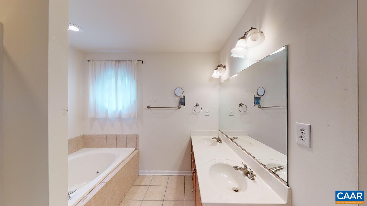 9 Tanglewood Road Palmyra, VA 22963 - Photo 14 of 34 a bathroom with a tub sink and mirror