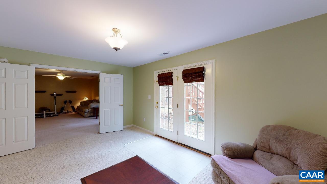 9 Tanglewood Road Palmyra, VA 22963 - Photo 23 of 34 a living room with furniture and a chandelier