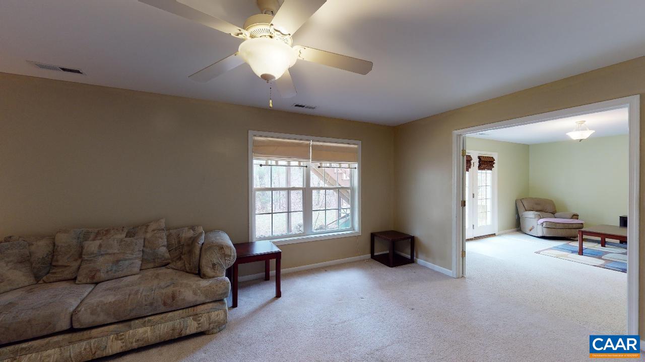 9 Tanglewood Road Palmyra, VA 22963 - Photo 27 of 34 a living room with furniture and a chandelier