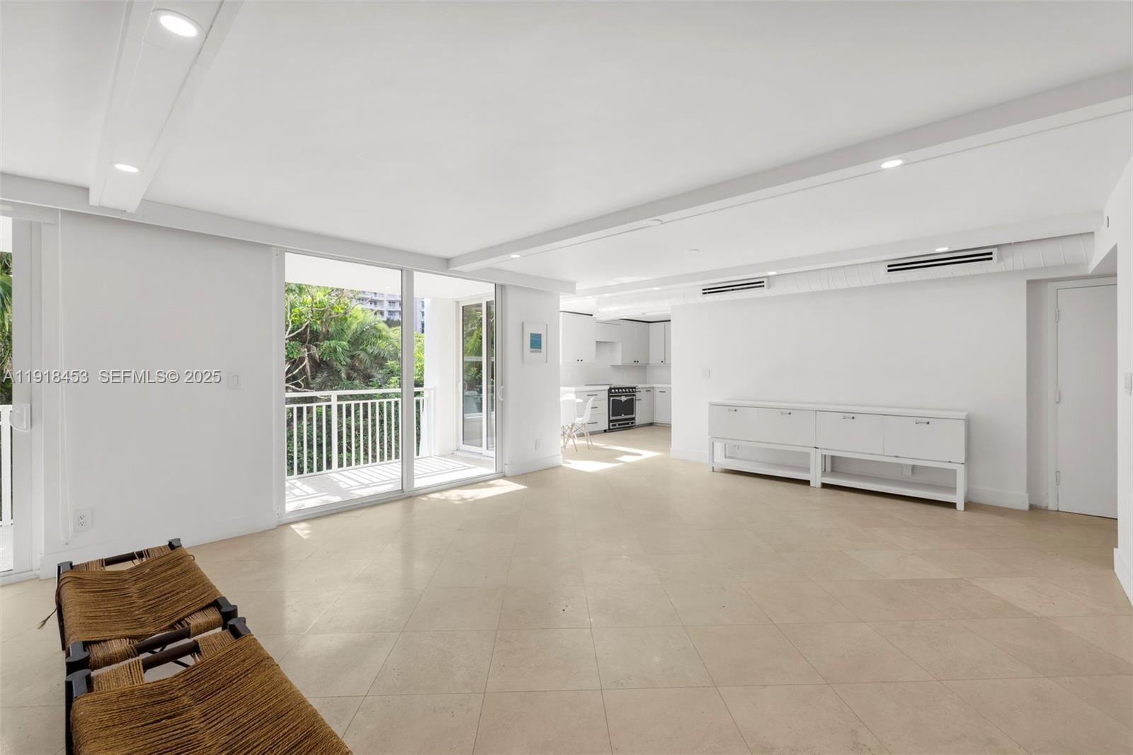 605 Ocean Drive, Unit 2L Key Biscayne, FL 33149 - Photo 11 of 46 a view of empty room with wooden floor and fan