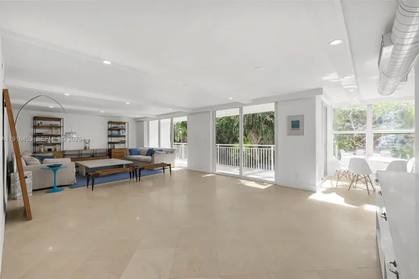 a living room with furniture and a floor to ceiling window