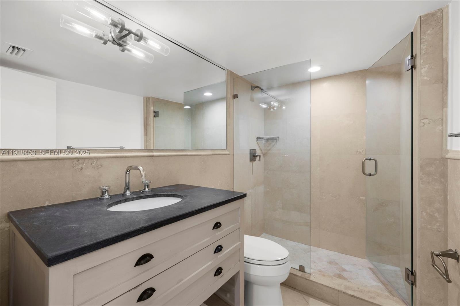 605 Ocean Drive, Unit 2L Key Biscayne, FL 33149 - Photo 28 of 46 a bathroom with a sink a toilet and shower