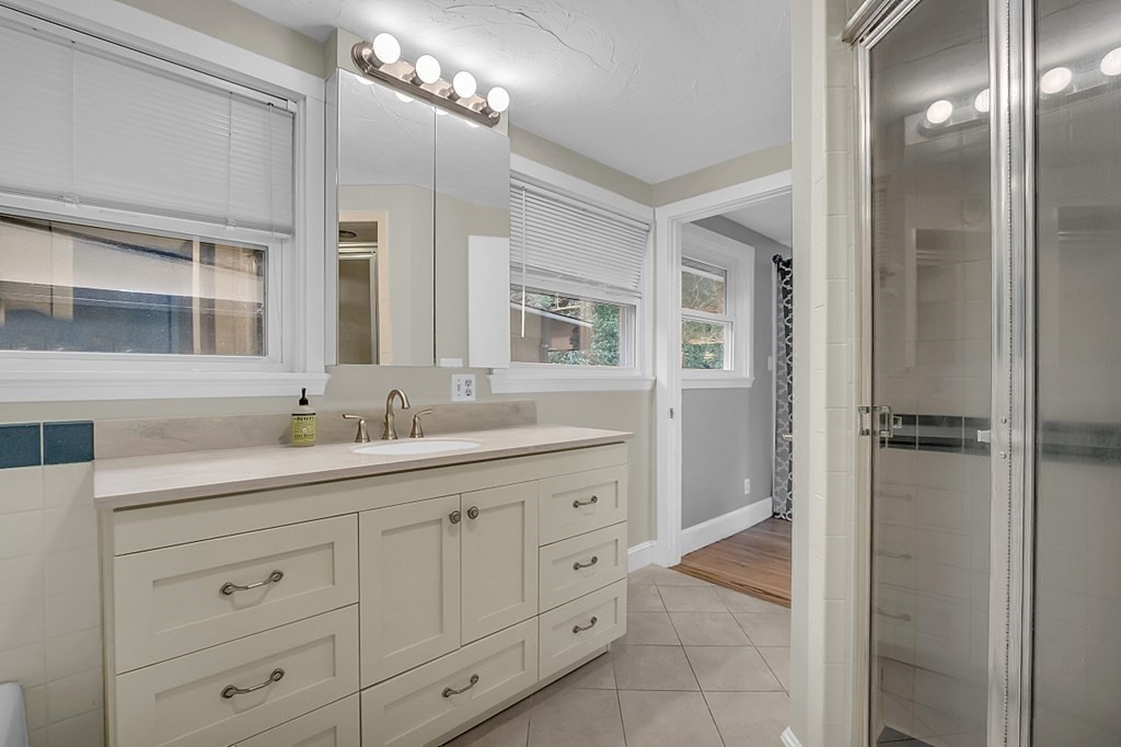 69 Aberdeen Road Weston, MA 02493 - Photo 18 of 30 a bathroom with a granite countertop sink mirror and double