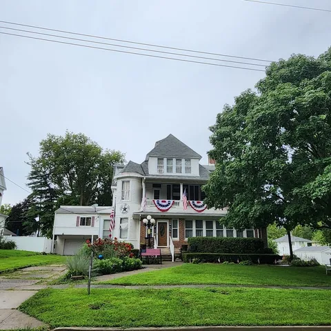 a front view of a house with a garden
