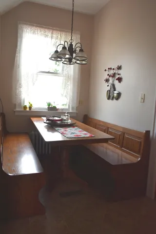 a view of a dining room with furniture and a fireplace