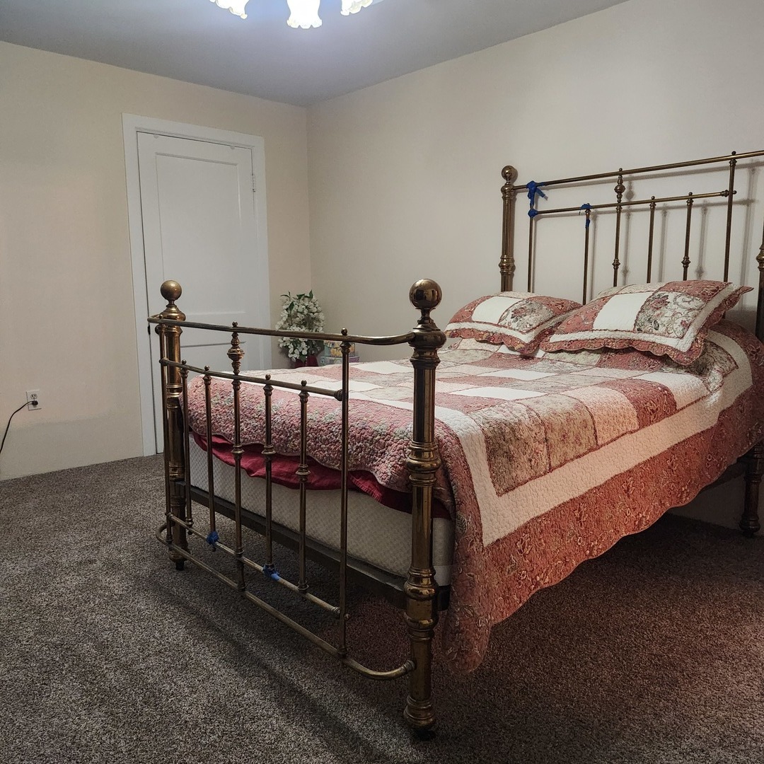 330 East Locust Street Watseka, IL 60970 - Photo 29 of 72 a bed sitting in a bedroom next to a window