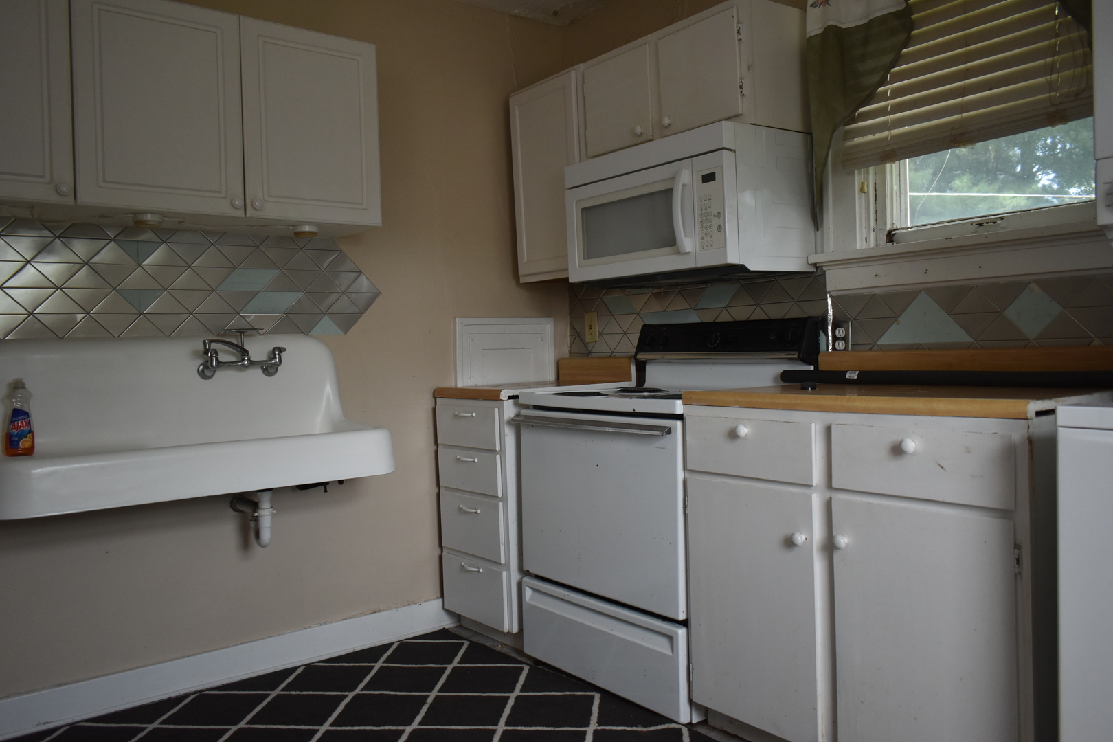 330 East Locust Street Watseka, IL 60970 - Photo 47 of 72 a kitchen with white cabinets and white appliances