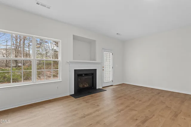 a view of empty room with a fireplace