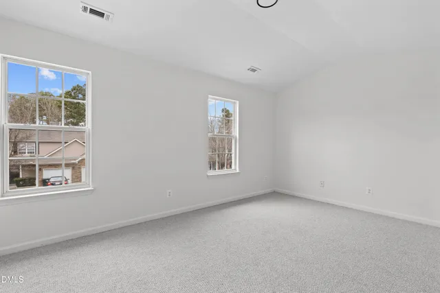 an empty room with windows and closet