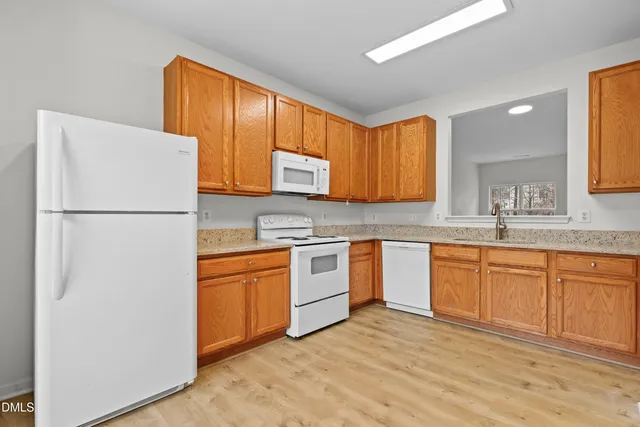 a kitchen with stainless steel appliances granite countertop a refrigerator sink and cabinets