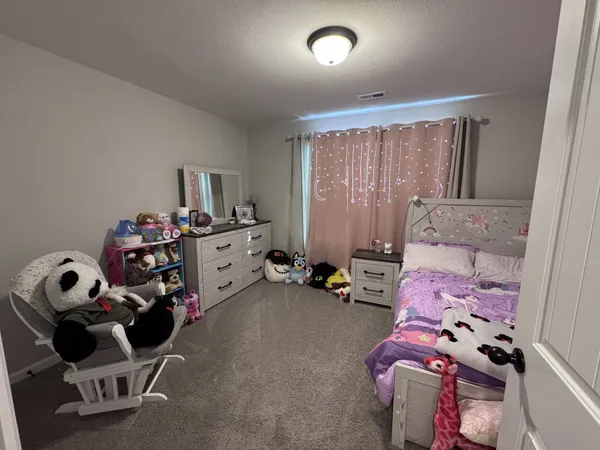 a bedroom with furniture and a window