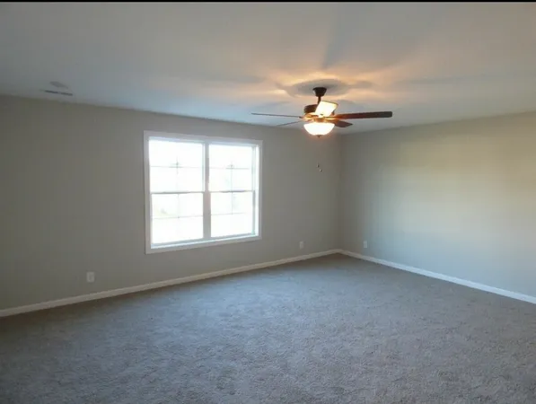 a view of a backyard with a slide and swing