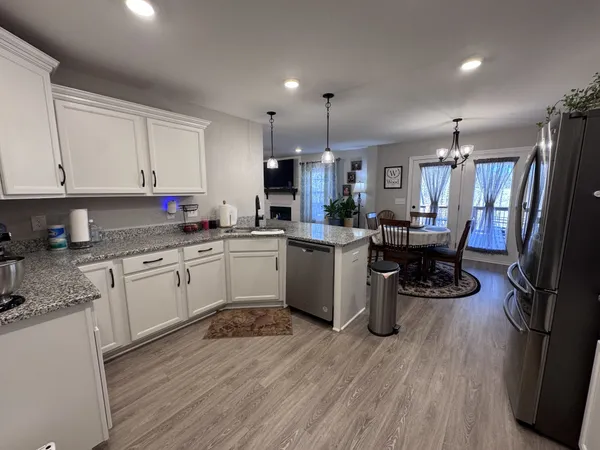 a kitchen with a sink cabinets and wooden floor