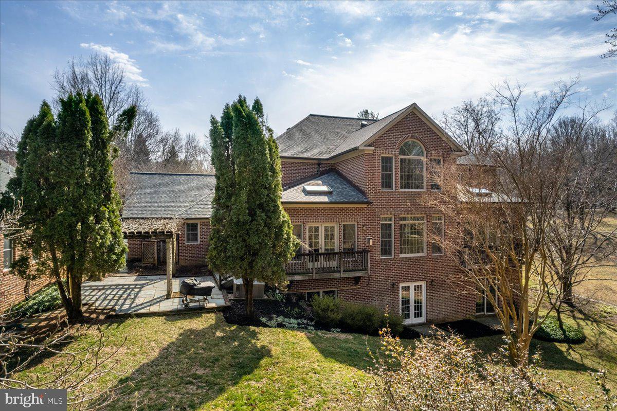 13635 Maidstone Lane Potomac, MD 20854 - Photo 58 of 66 Patio w trellis incl lush wisteria in summer