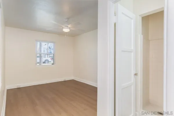 a view of a hallway with wooden floor