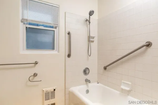 a bathroom with a tub and a shower