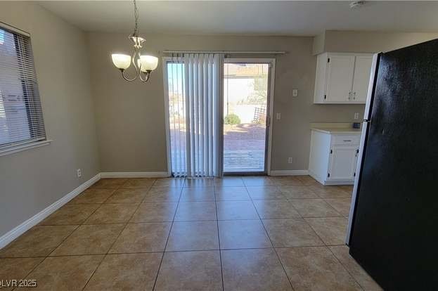1016 Vantage Point Road Las Vegas, NV 89128 - Photo 4 of 18 Unfurnished dining area featuring light tile patterned flooring, a notable chandelier, and baseboards