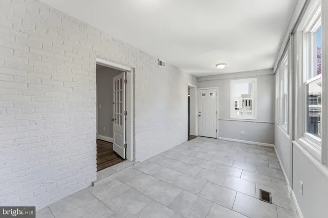 a view of a room with wooden floor and a ceiling fan