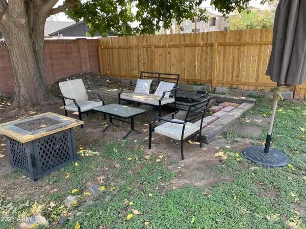 a backyard of a house with table and chairs