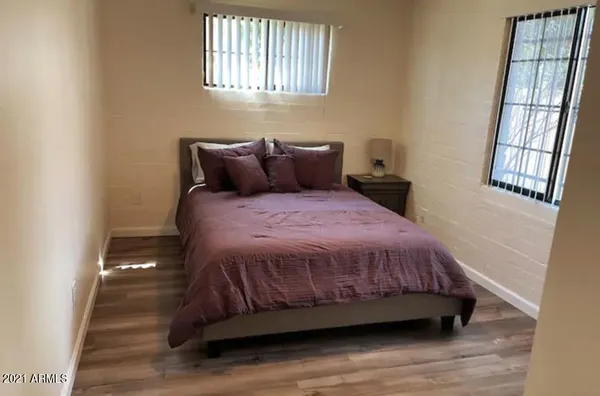 a bed sitting in a bedroom next to a window