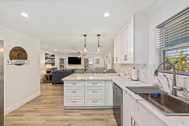a kitchen with a sink stove and cabinets