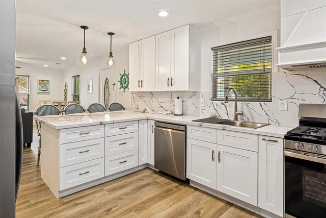 a kitchen with a sink stove and cabinets