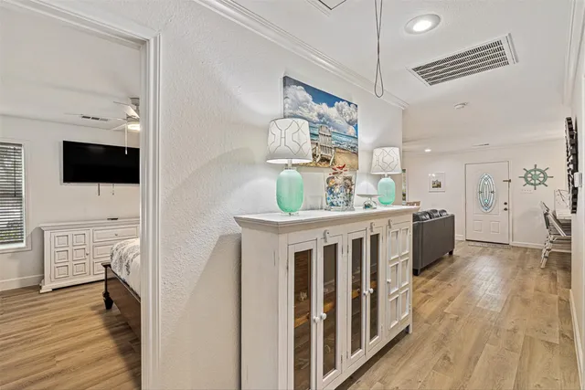 a view of kitchen with kitchen island wooden floors appliances