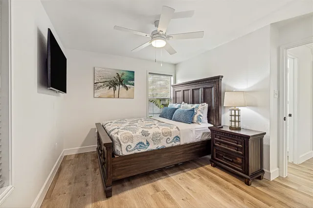 a bedroom with bed and flat screen tv