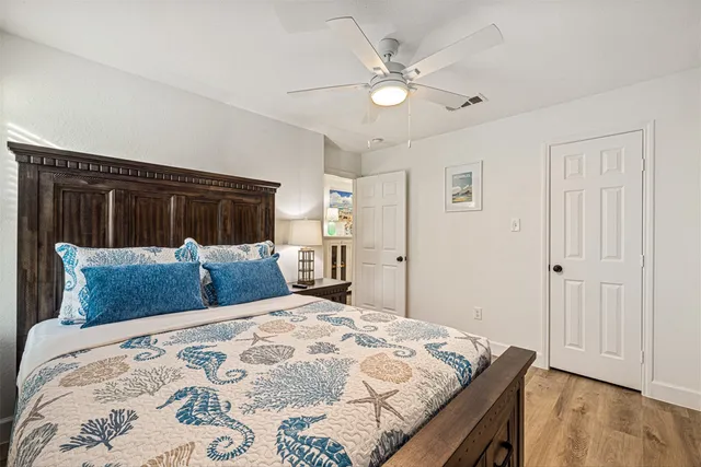 a bedroom with a large bed and a chandelier