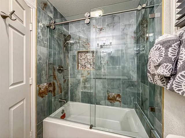 a bathroom with a bathtub and shower