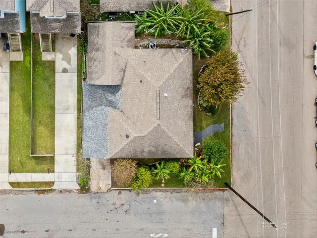 an aerial view of a house with a yard