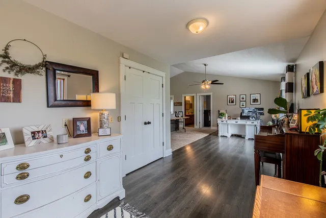 a view of a dining room and livingroom with furniture wooden floor a chandelier