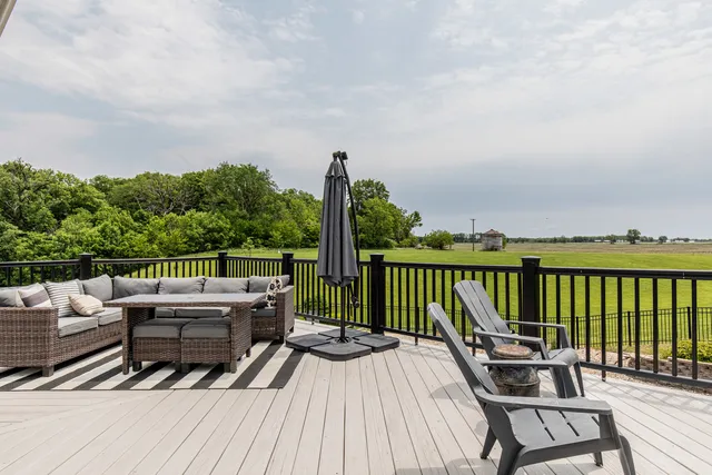 a view of a balcony with wooden floor and seating space