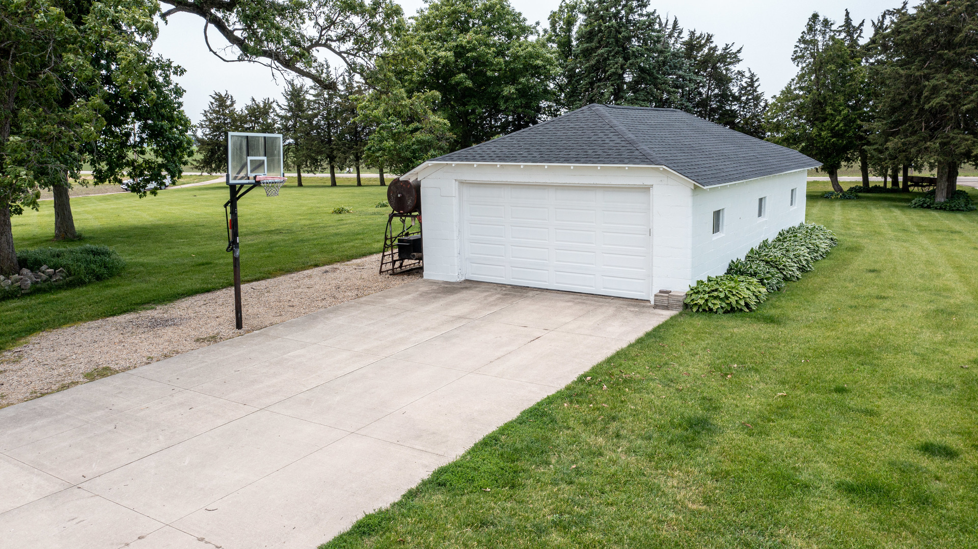 3980 East 4th Road Mendota, IL 61342 - Photo 31 of 44 a white house with a small yard and big trees