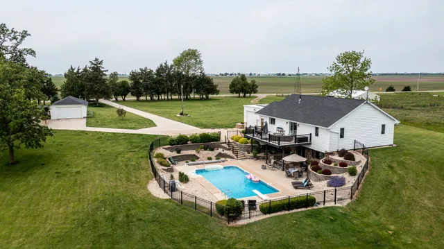 an aerial view of a house with swimming pool garden and outdoor seating