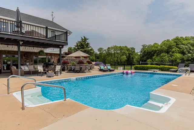 a view of a swimming pool with an outdoor seating