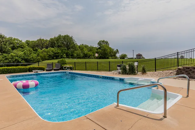 swimming pool view with a seating space