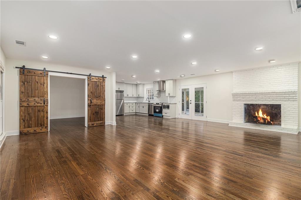 1110 Upper Hembree Road Roswell, GA 30076 - Photo 13 of 51 a view of empty room with wooden floor and fireplace