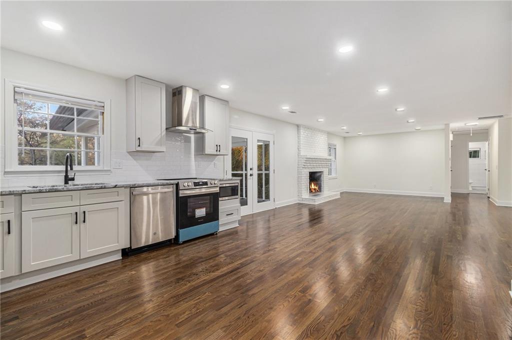 1110 Upper Hembree Road Roswell, GA 30076 - Photo 16 of 51 a large kitchen with stainless steel appliances lot of white cabinets and wooden floor