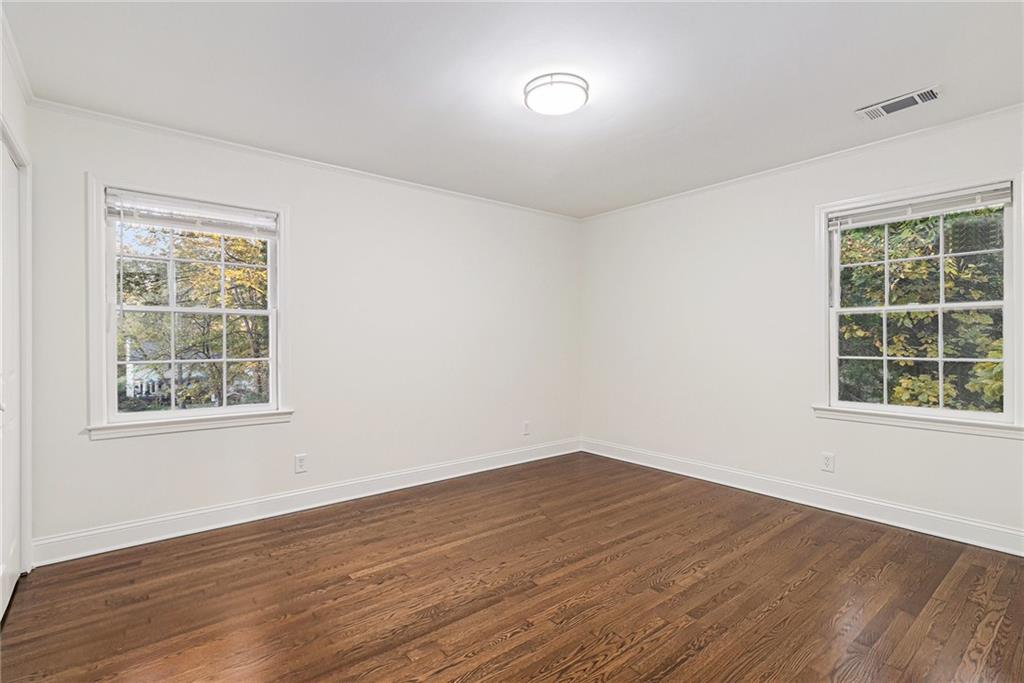 1110 Upper Hembree Road Roswell, GA 30076 - Photo 18 of 51 an empty room with wooden floor and windows