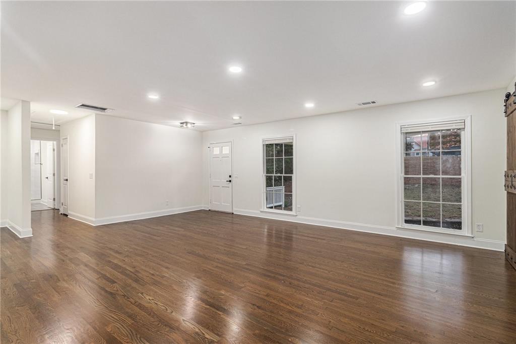 1110 Upper Hembree Road Roswell, GA 30076 - Photo 20 of 51 an empty room with wooden floor and windows
