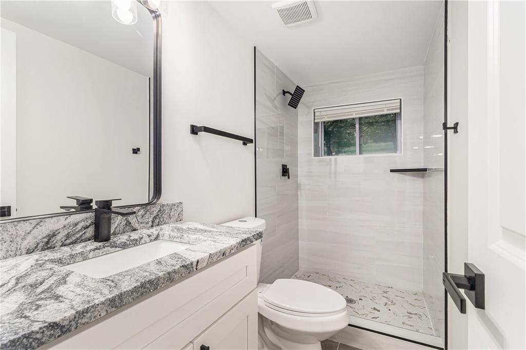 1110 Upper Hembree Road Roswell, GA 30076 - Photo 23 of 51 a bathroom with a granite countertop sink toilet and shower