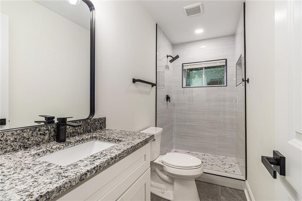 1110 Upper Hembree Road Roswell, GA 30076 - Photo 24 of 51 a bathroom with a granite countertop sink toilet and shower