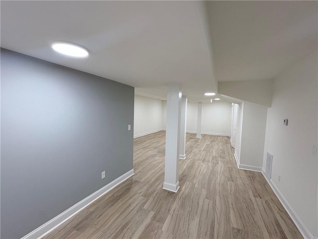 1110 Upper Hembree Road Roswell, GA 30076 - Photo 25 of 51 a view of an empty room with wooden floor